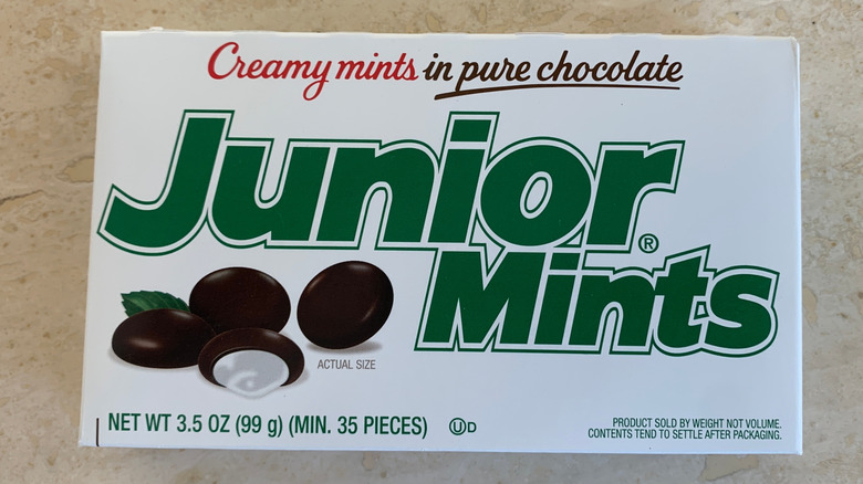 A box of Junior Mints, seen on a marble background