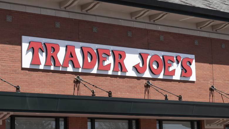 A Trader Joe's sign on a brick wall above the store's front entrance.