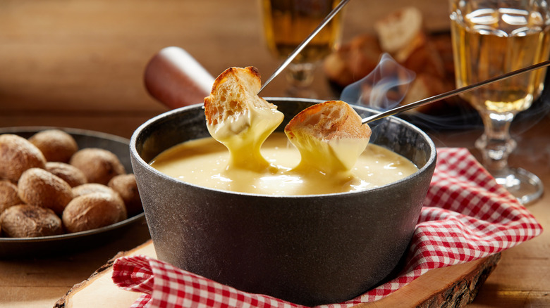bread being dipped into fondue