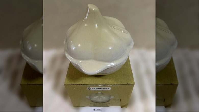 A Le Creuset mini cocotte shaped like a garlic bulb, in the Meringue color