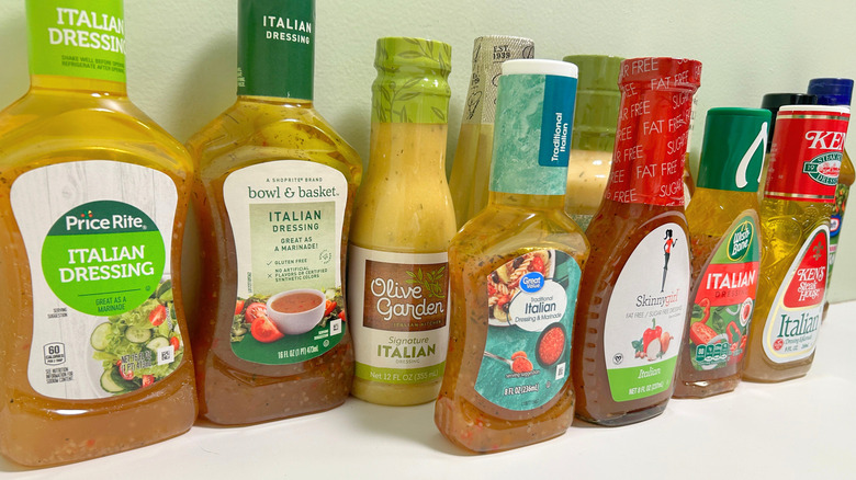 Close up of several Italian dressing bottles arranged in two rows