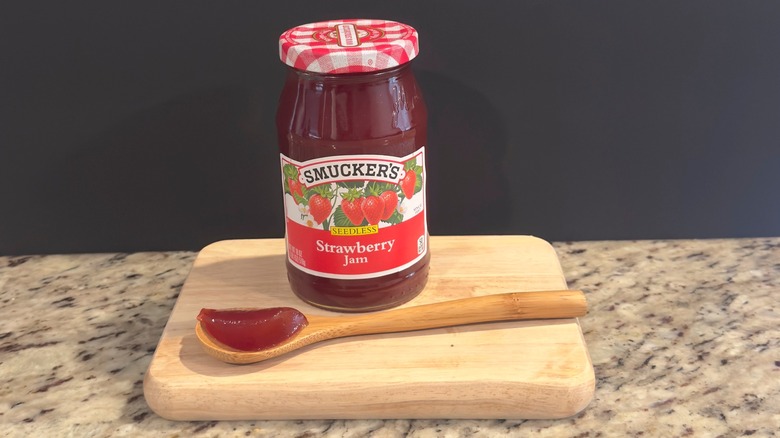 Jar of Smucker's Strawberry Jam with sample on spoon
