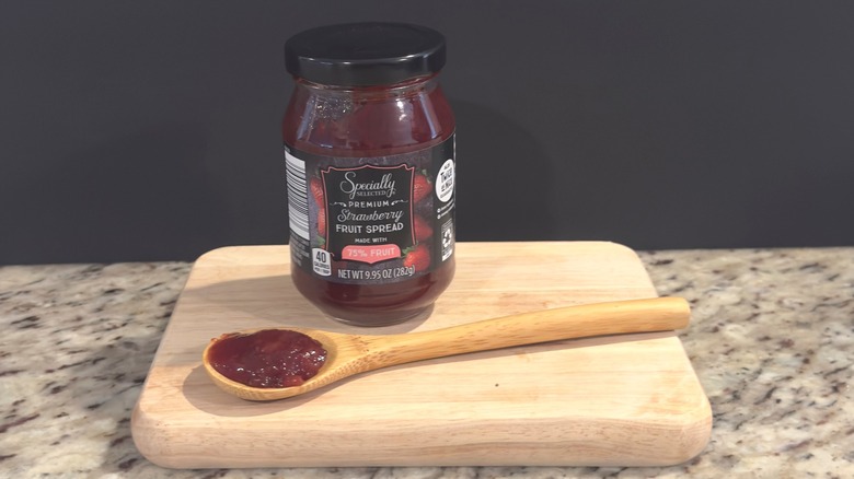 Jar of Specially Selected Fruit Spread with sample on spoon