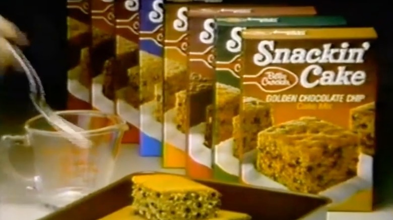 A Betty Crocker Snackin' Cake commercial still featuing multiple boxes of cake mix