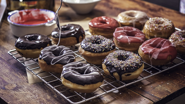 Decorating homemade colorful donuts