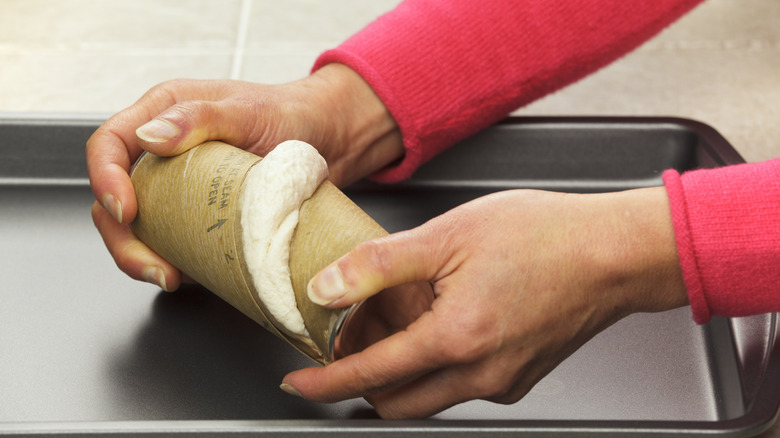 Opening can of biscuits