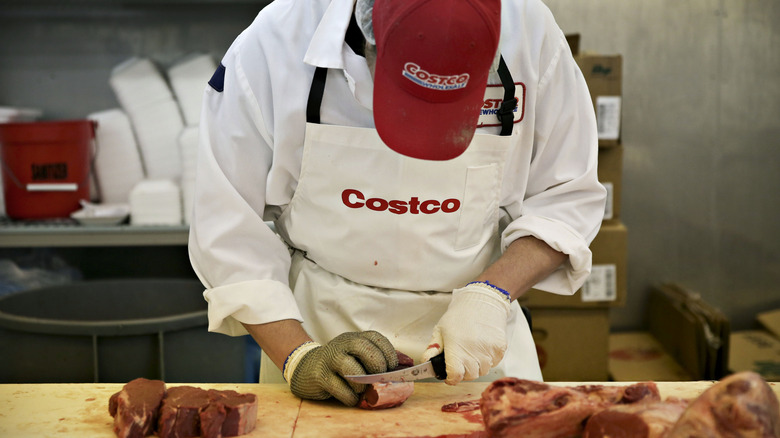 Costco butcher cutting meat