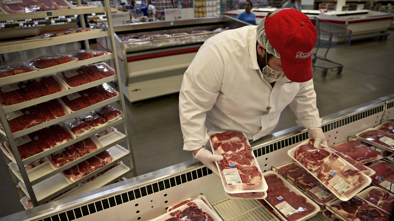 Costco butcher sorting meat