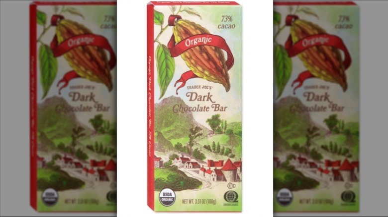 Organic dark chocolate bar with a red and green label on white background