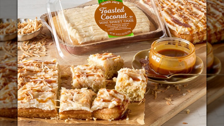 Trader Joe's Toasted Coconut Mini Sheet Cake on display with the package and a jar of caramel sauce.