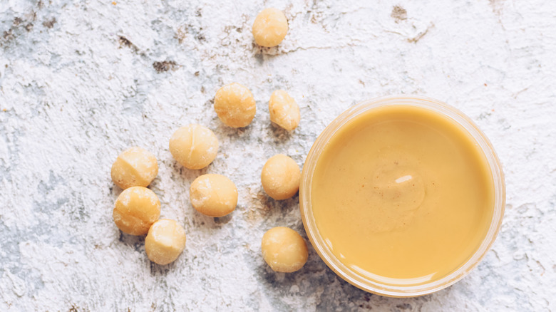 Jar of yellowish-beige macadamia butter