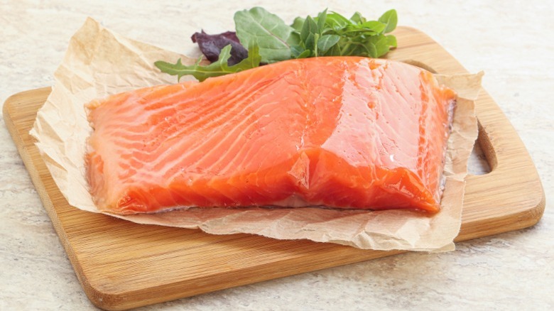 Raw salmon on cutting board