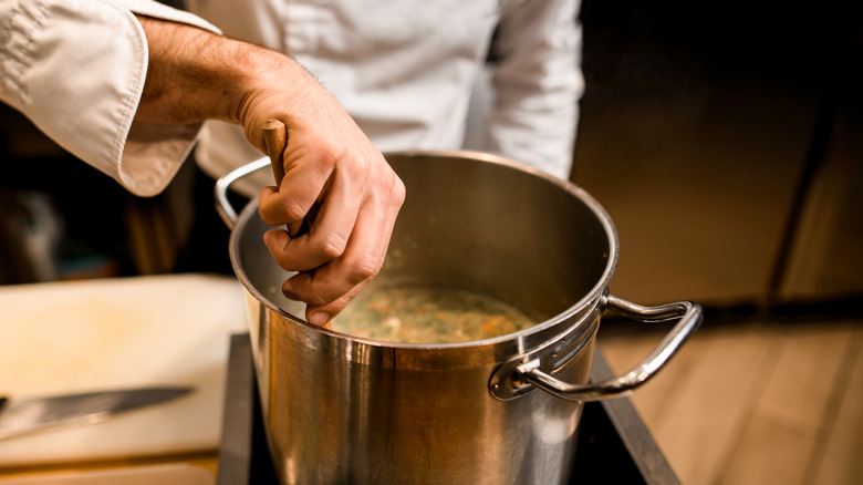 chef making soup broth