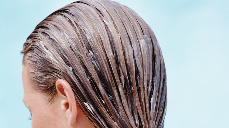 woman with conditioner in hair