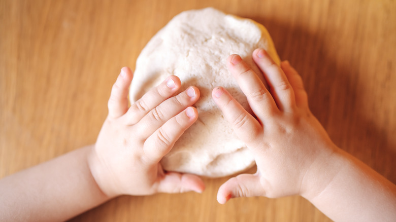 kid playing with homemade play dough