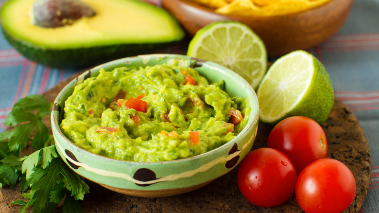 Guacamole with tomatoes and limes