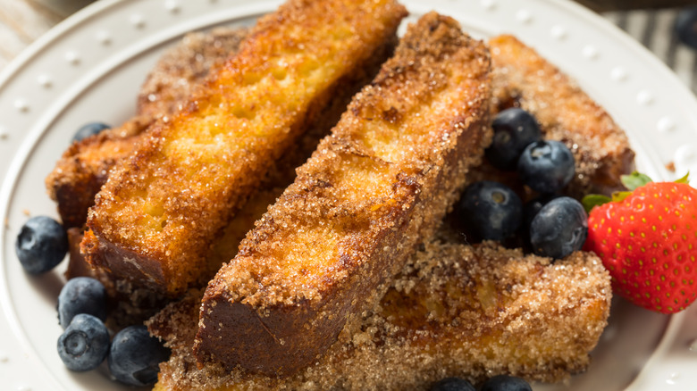 French toast sticks on pile of fruit