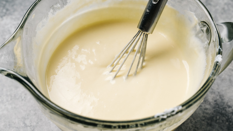 Custard in bowl, with whisk sitting in it