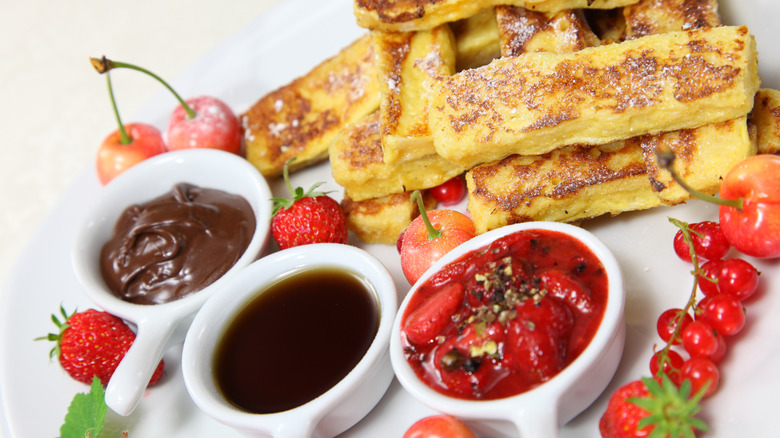 French toast sticks with chocolate dipping sauce, maple syrup, and fruit