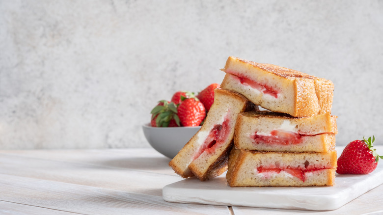 Slices of stuffed French toast, with a strawberry and cream cheese filling