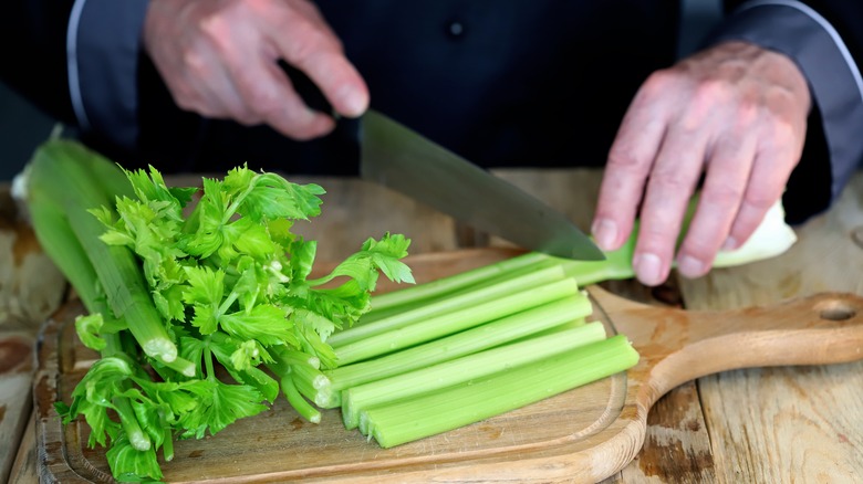 Person cutting celery