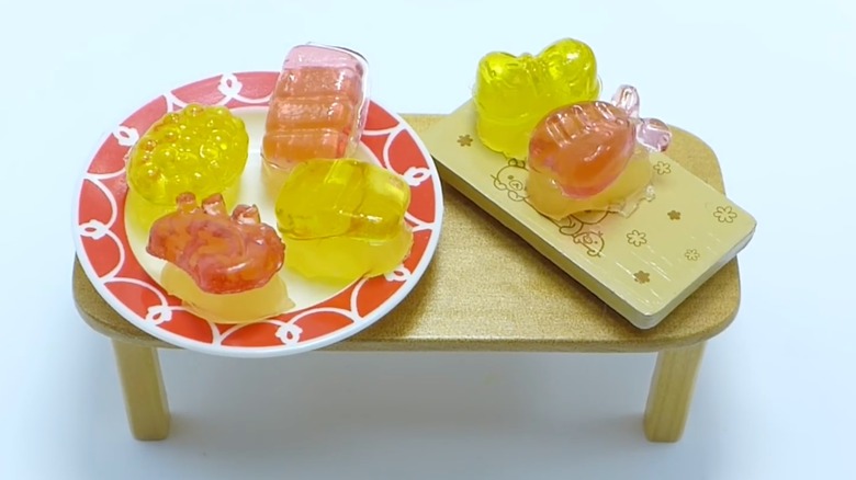 Meiji Nigi-Nigi Sushi Gummy Candies shaped like sushi on toy table and plate set