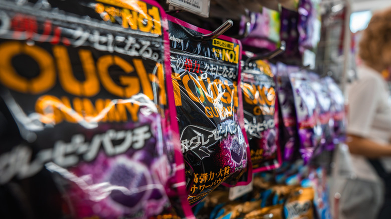 Tough Gummy packages hanging from shelves in a supermarket