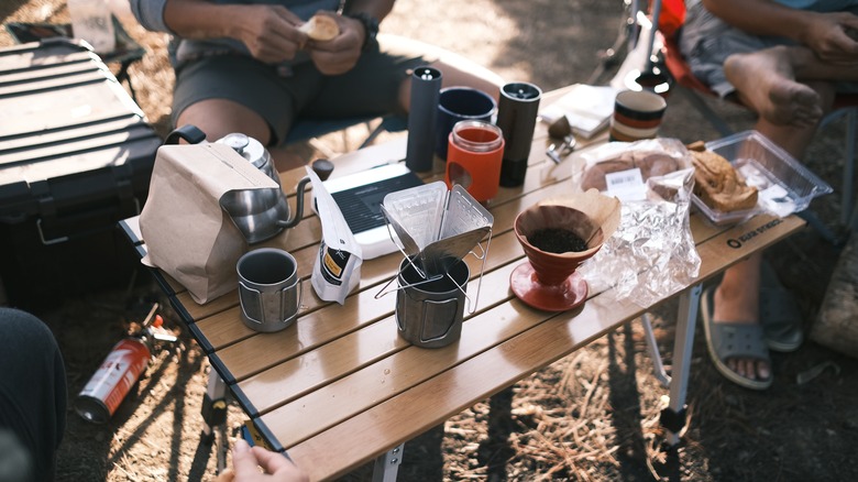 Table covered in camping cooking gear