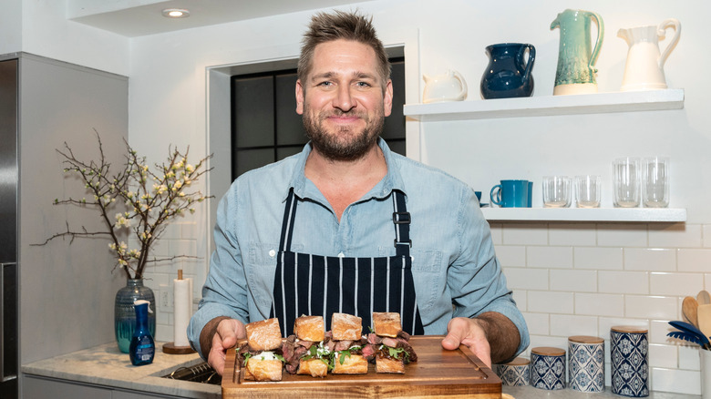 Chef Curtis Stone with sandwiches