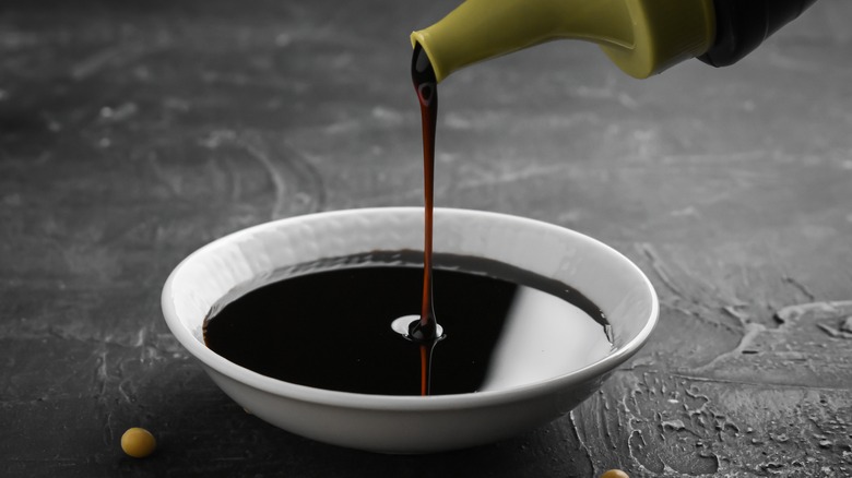 Soy sauce pouring into bowl