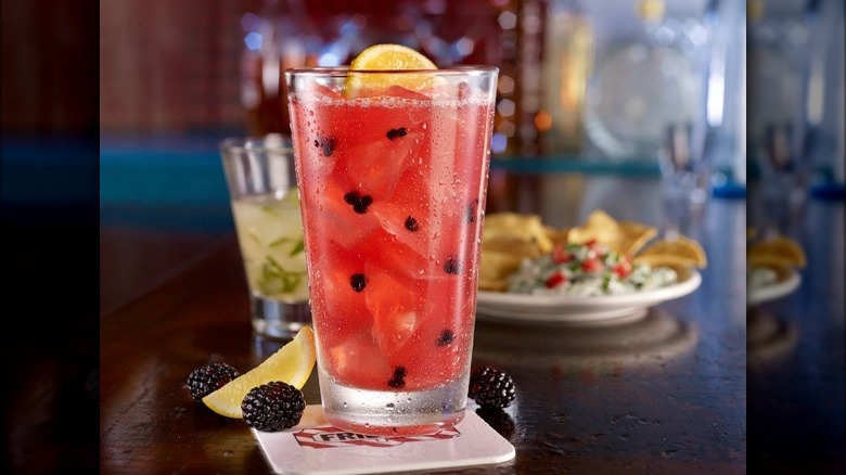 pink cocktail with blackberries