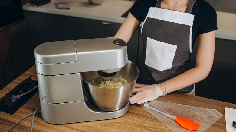 Person using electric mixer
