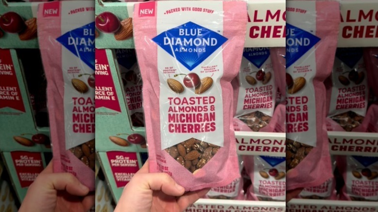 Hand holding Blue Diamond almonds bag