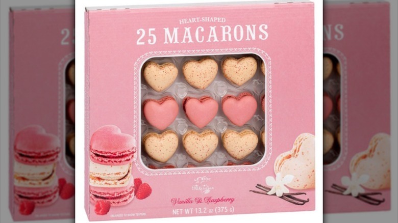 Box of heart macarons on white background