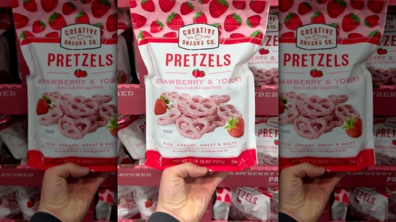 Hand holding strawberry yogurt pretzels