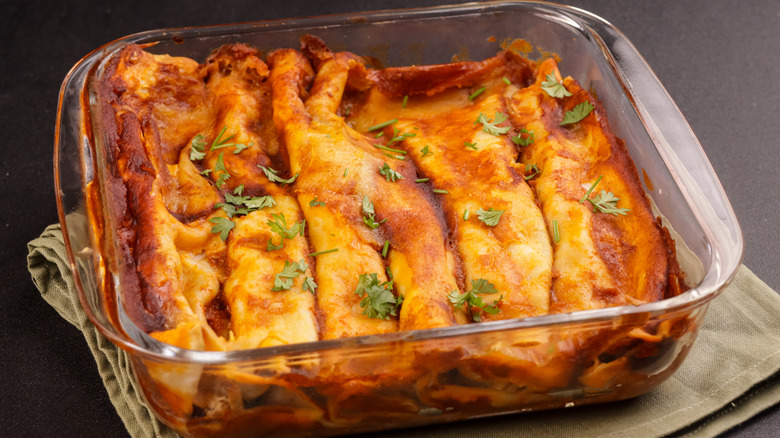 Chicken enchiladas in a glass dish