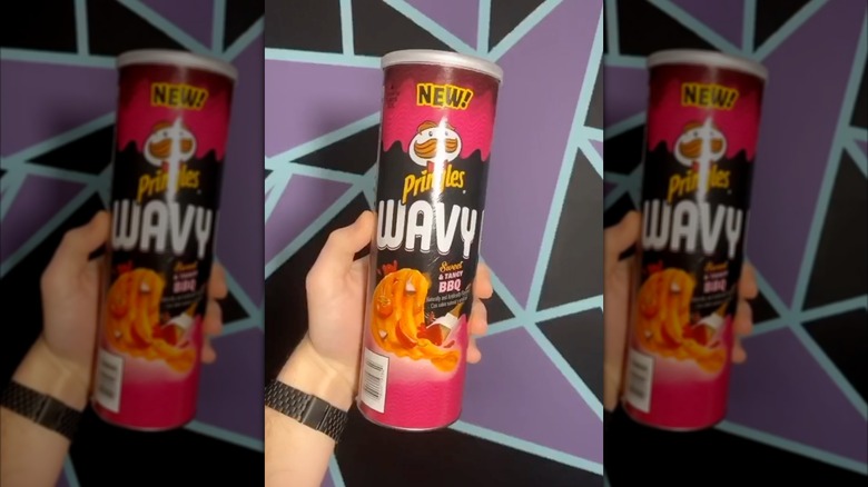 Hand holding Wavy Sweet & Tangy BBQ Pringles