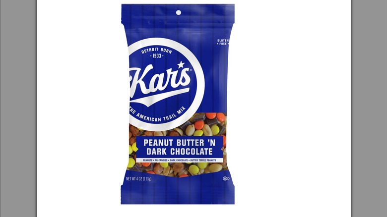 A royal blue bag of Kar's Peanut Butter 'n Dark Chocolate Trail Mix against a white background.