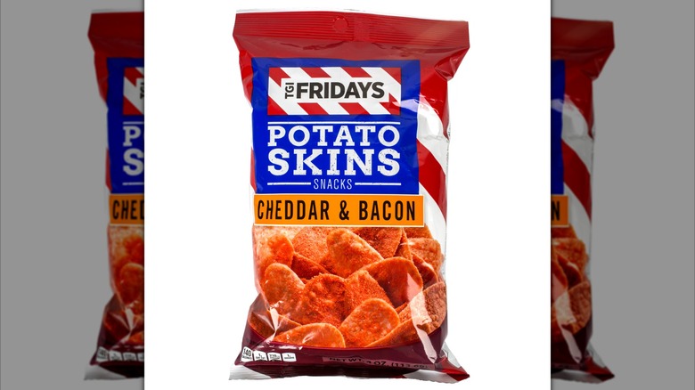 A bag of T.G.I. Friday's Cheddar & Bacon Potato Skins with red, white, and blue packaging with a photo of the chips on the bag.
