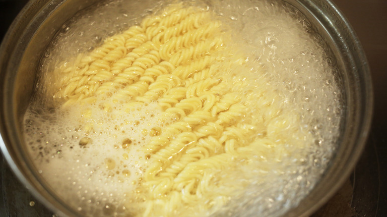 Instant ramen noodles boiling in water