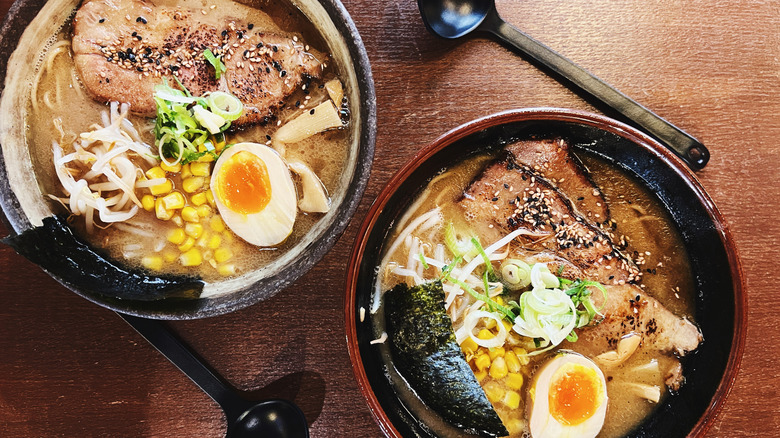 Two bowls of tonkotsu ramen with pork slices and halved eggs