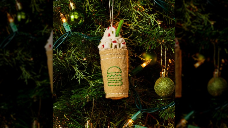 A Christmas Cookie Shake Ornament hanging on a tree