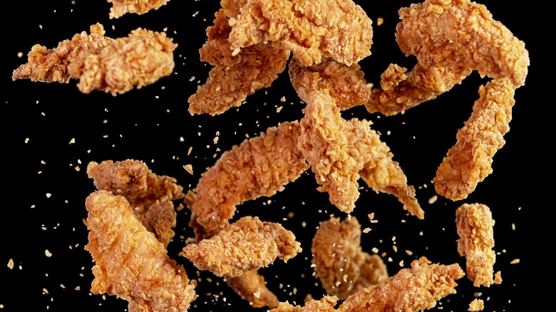 Fried chicken tenders on black background