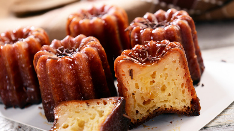Several canelés with one in front slice down the middle