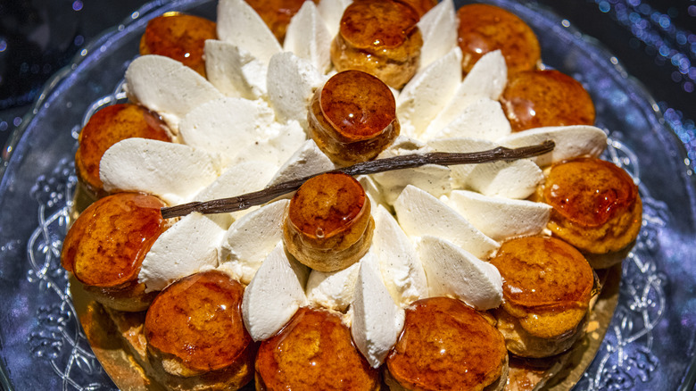 La Gâteau Saint-Honoré With a long vanilla bean laid overtop