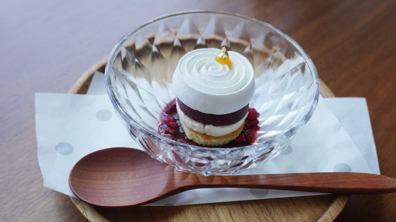 A small vacherin in a bowl with a beautiful swirl of meringue on top