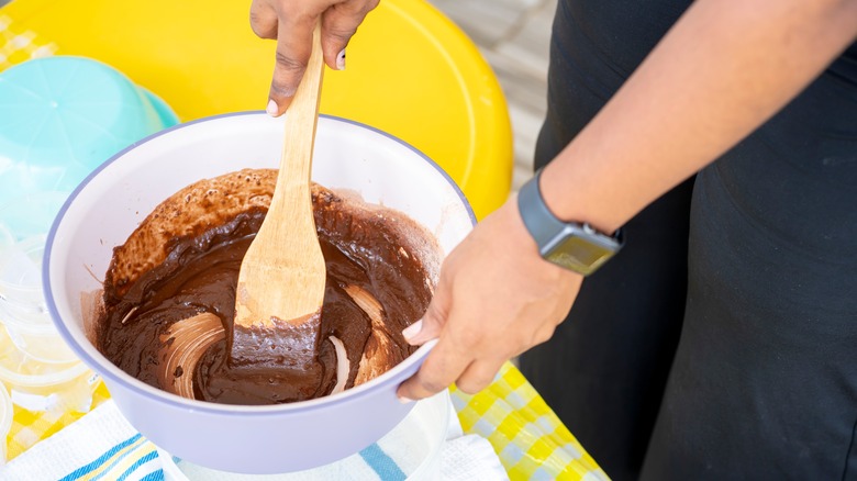 Hand stirring bowl of pudding