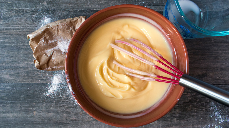 Whisking pudding in bowl