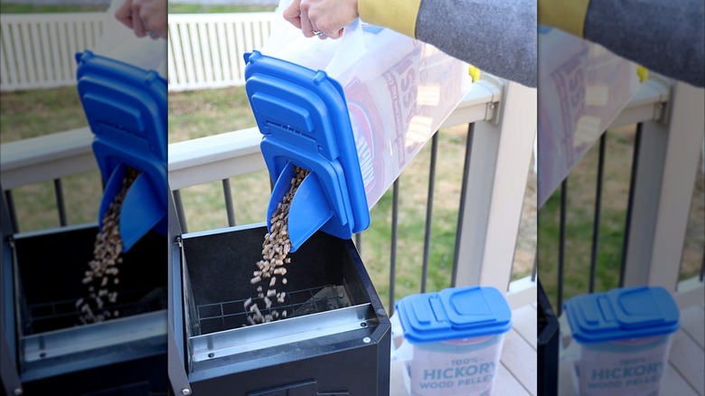 Pouring pellets into grill/smoker using the Kingsford wood pellet dispenser