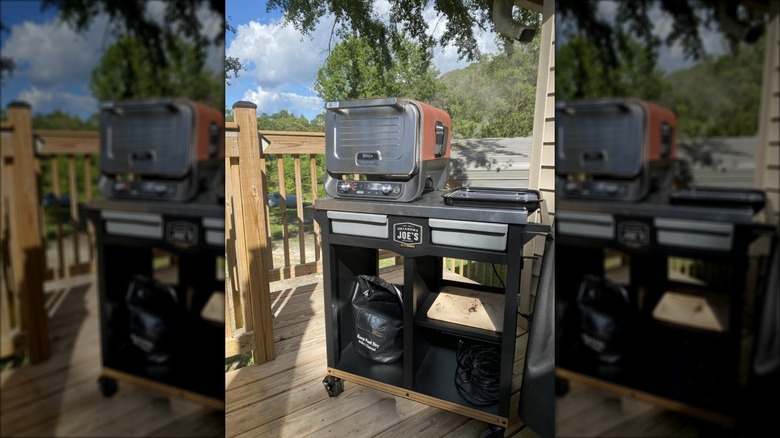 Oklahoma Joe's rolling workstation prep and storage on a deck with Ninja grill and accessories